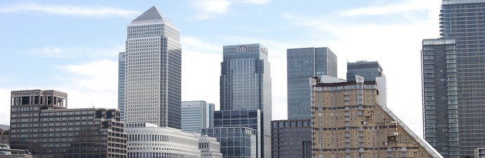 View of sky scrapers against a blue sky forming the Canary Wharf skyline.