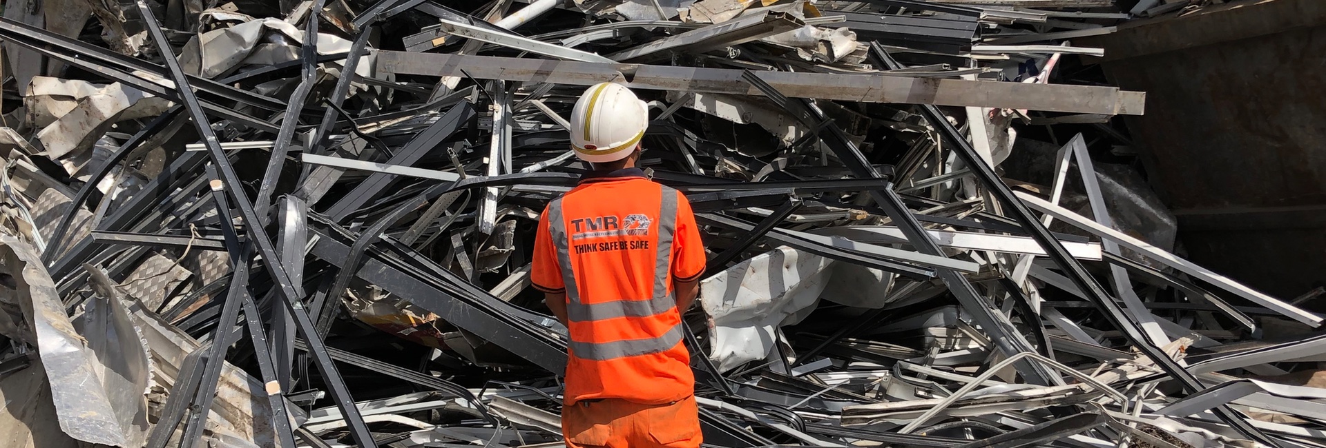 TMR worker inspecting a stockpile of Aluminium