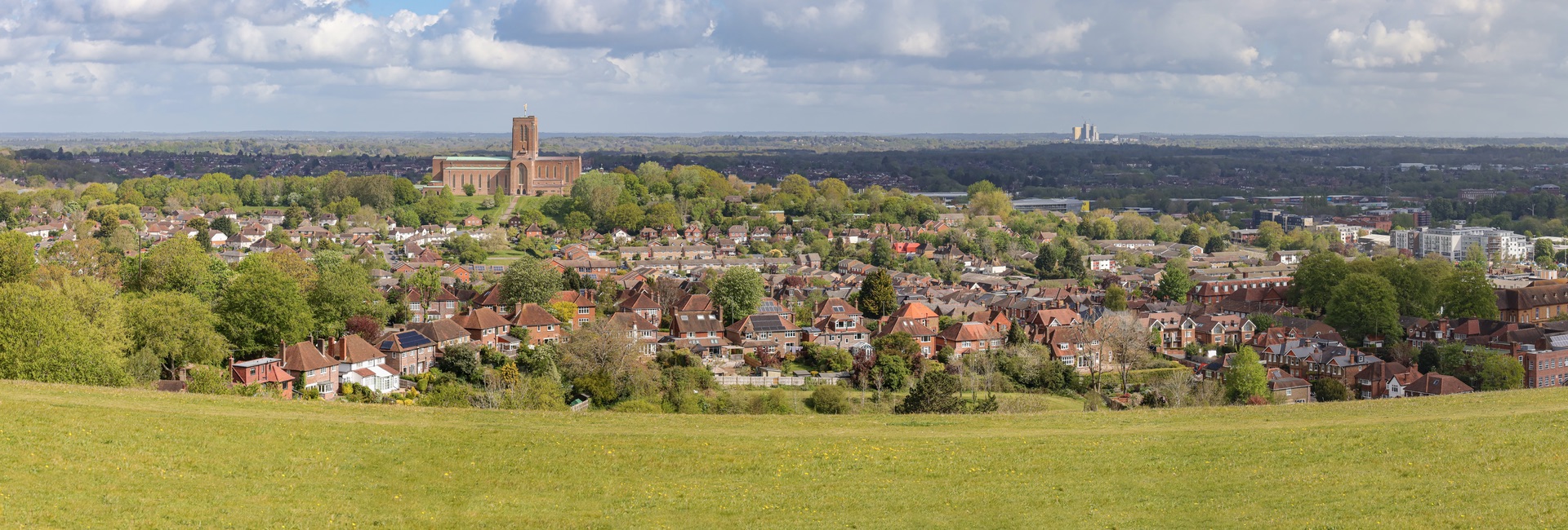 View from a hillside in Surrey of Guildford cathedral in the distance and the town below.