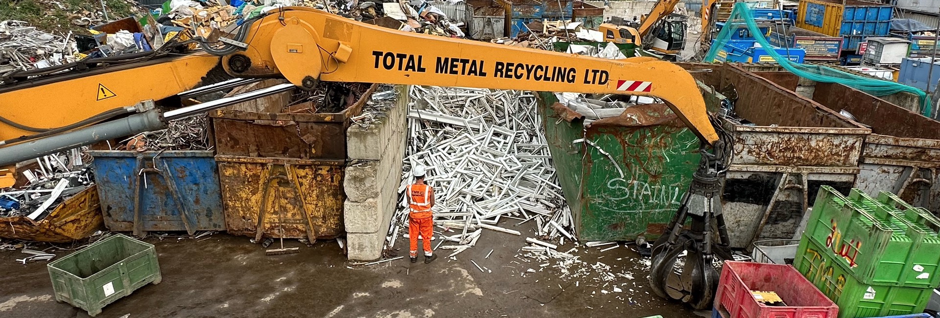 Worker wearing high-vis inspecting a uPVC window recycling bay
