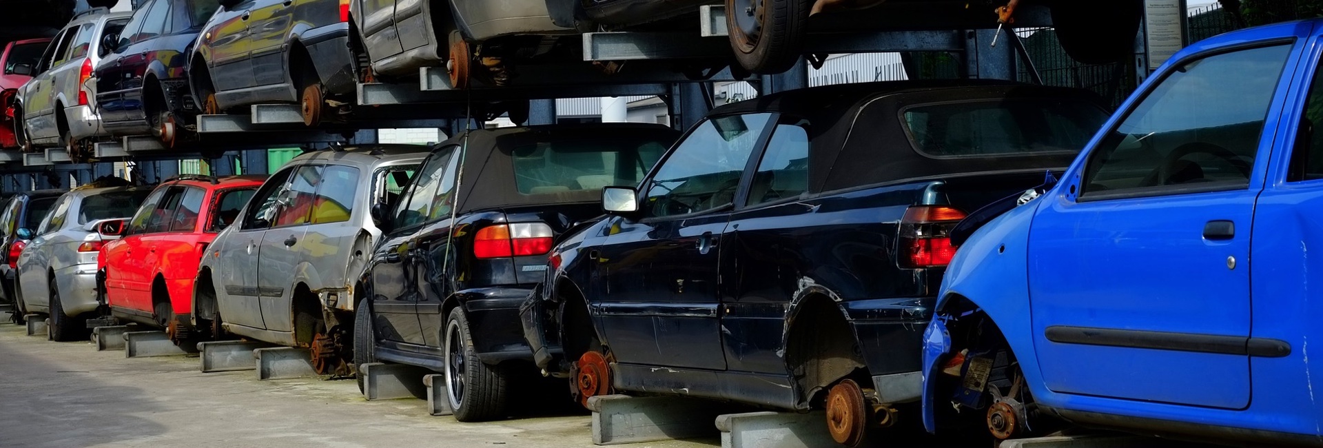 Scrap vehicles stacked on a rack for recycling